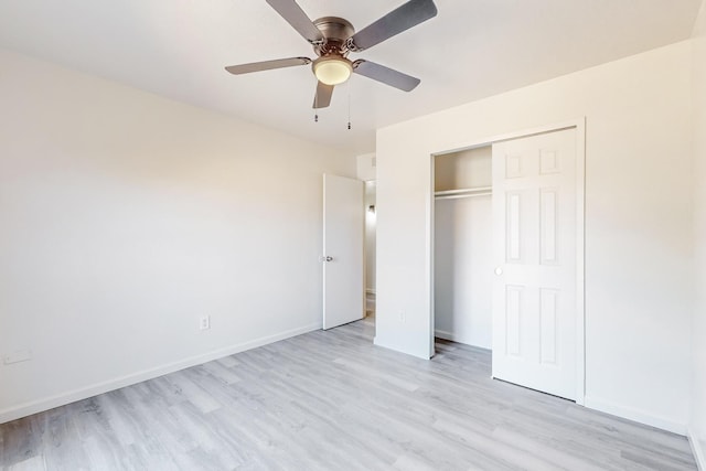 unfurnished bedroom with ceiling fan, light hardwood / wood-style floors, and a closet