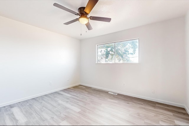 empty room with light hardwood / wood-style floors and ceiling fan