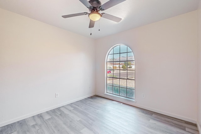 unfurnished room with ceiling fan and light wood-type flooring