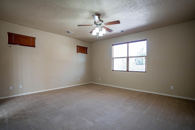 unfurnished room with ceiling fan, a textured ceiling, and carpet floors