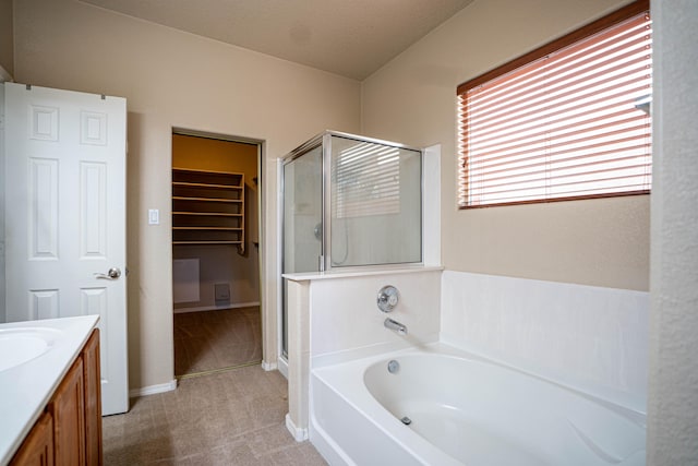 bathroom with vanity, independent shower and bath, and a textured ceiling