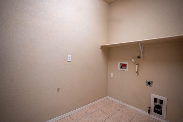 laundry area featuring gas dryer hookup, hookup for a washing machine, light tile patterned flooring, and electric dryer hookup