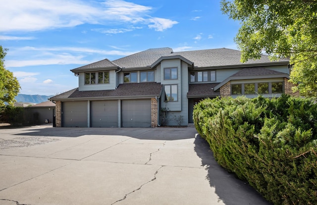 view of front of house featuring a mountain view and a garage