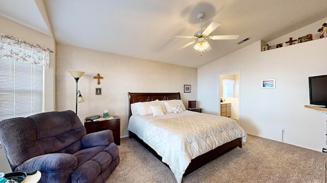 carpeted bedroom with connected bathroom, vaulted ceiling, and ceiling fan