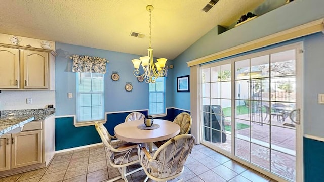 tiled dining space with a notable chandelier, a textured ceiling, and lofted ceiling