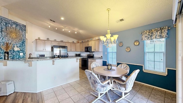 dining area with a wealth of natural light, vaulted ceiling, a notable chandelier, and light tile patterned flooring