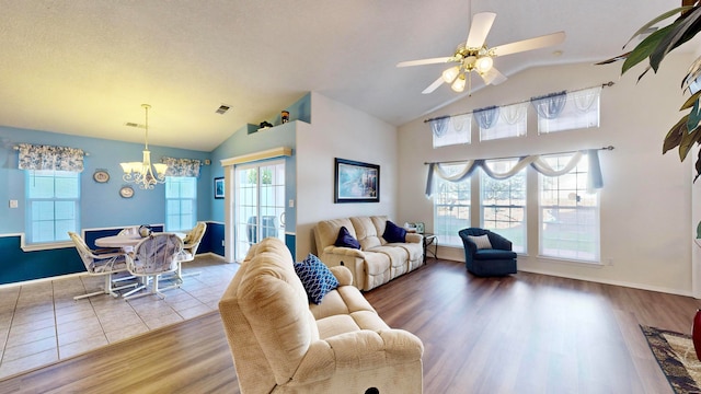 living room featuring vaulted ceiling, a wealth of natural light, and light wood-type flooring