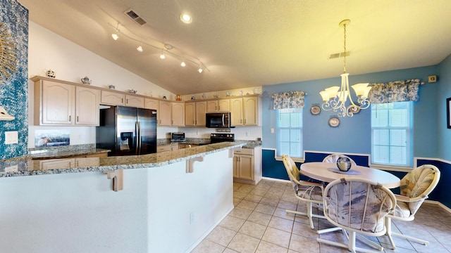 kitchen with light stone countertops, black appliances, lofted ceiling, decorative light fixtures, and light brown cabinets