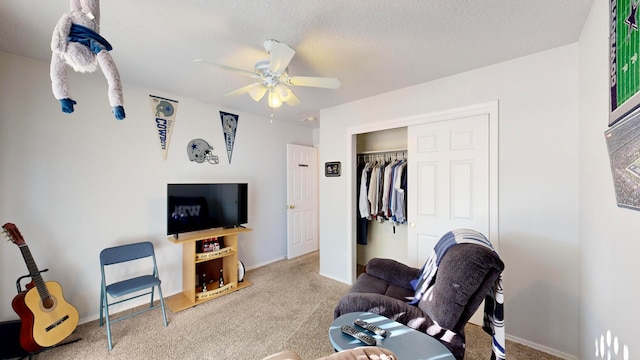 carpeted living room with a textured ceiling and ceiling fan