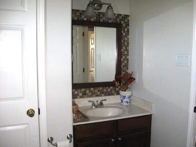 bathroom with decorative backsplash and vanity