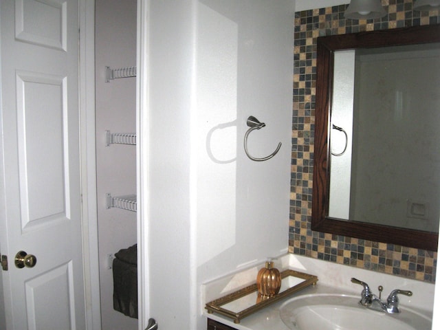 bathroom featuring vanity and decorative backsplash