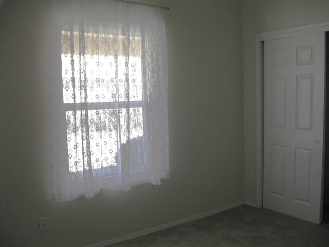 spare room featuring plenty of natural light and baseboards