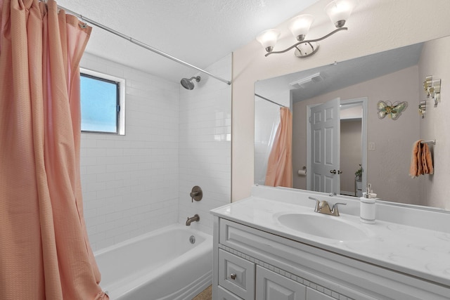 full bath with shower / tub combo, visible vents, a textured ceiling, and vanity