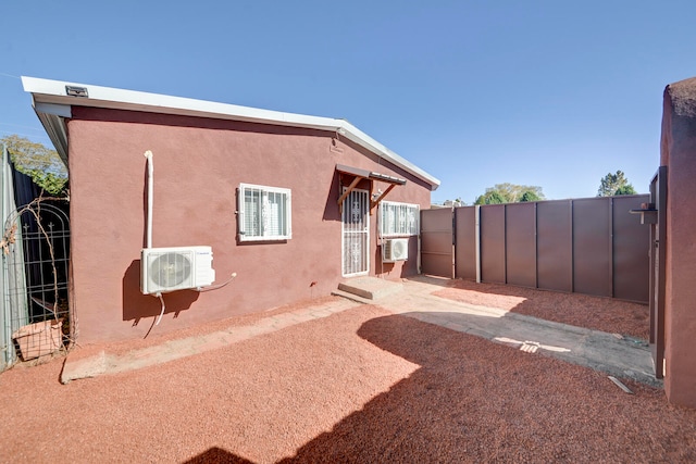 back of house featuring ac unit and cooling unit