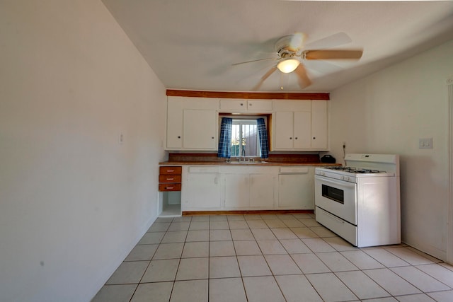 kitchen featuring white cabinetry, gas range gas stove, sink, and ceiling fan