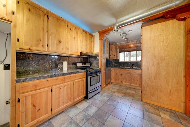 kitchen featuring stainless steel appliances, sink, and backsplash