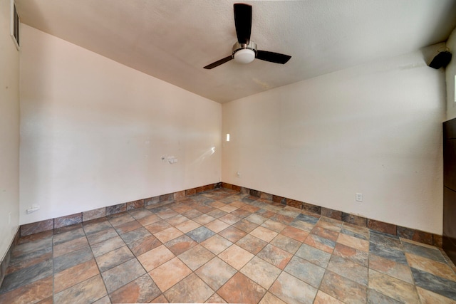 unfurnished room featuring ceiling fan and a textured ceiling