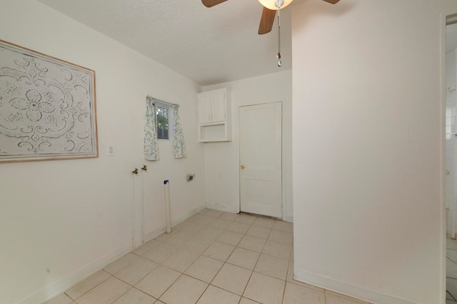 interior space with ceiling fan and a textured ceiling