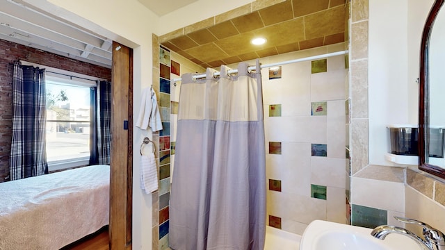 full bathroom with curtained shower and a sink