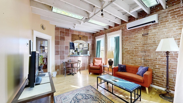 interior space featuring brick wall, beamed ceiling, a wall mounted air conditioner, and wood finished floors