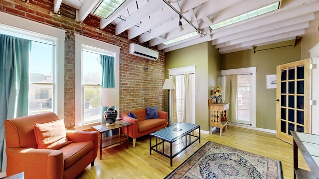 living area featuring beam ceiling, a wall mounted air conditioner, brick wall, and wood finished floors