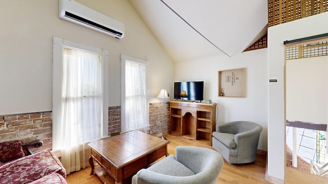 living area with light wood-type flooring, a healthy amount of sunlight, and an AC wall unit