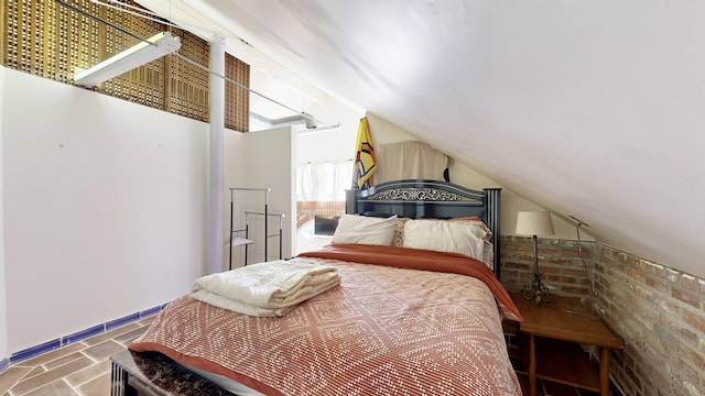 bedroom with vaulted ceiling and baseboards