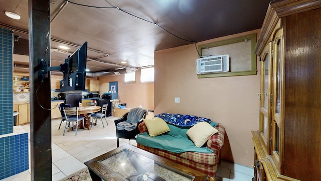 basement with a wall mounted air conditioner and tile patterned floors