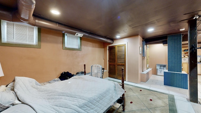 bedroom featuring recessed lighting, a closet, and tile patterned floors