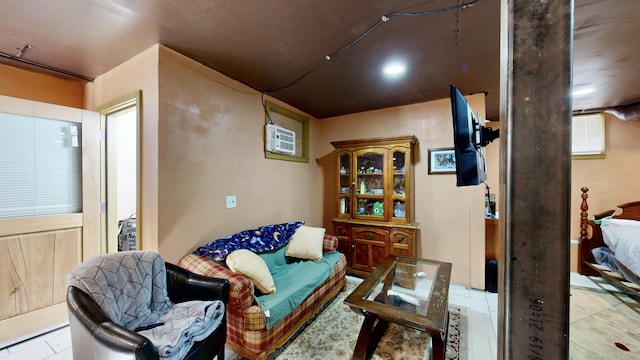 sitting room featuring a wall mounted air conditioner and tile patterned floors