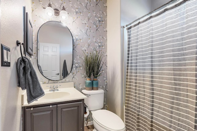 bathroom with toilet, curtained shower, and vanity