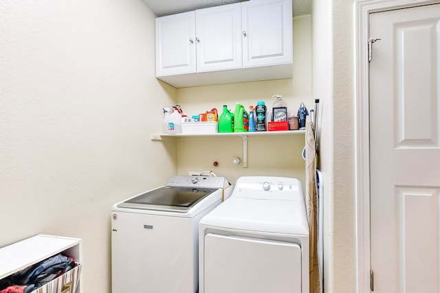 laundry area with cabinets and washing machine and clothes dryer