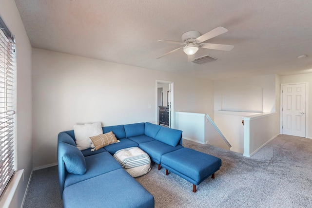 carpeted living room with ceiling fan