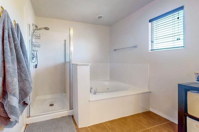 bathroom with plus walk in shower and tile patterned flooring