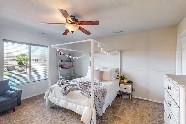 carpeted bedroom featuring a textured ceiling and ceiling fan