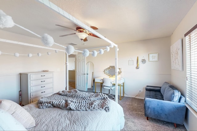 carpeted bedroom with ceiling fan and a textured ceiling