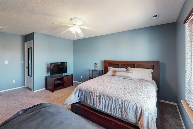 bedroom featuring a textured ceiling, carpet flooring, and ceiling fan