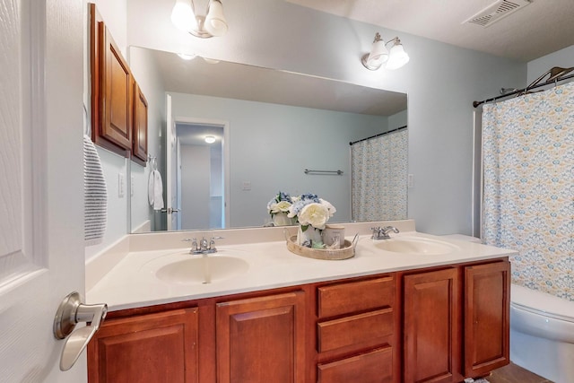 bathroom featuring vanity, toilet, and a shower with shower curtain