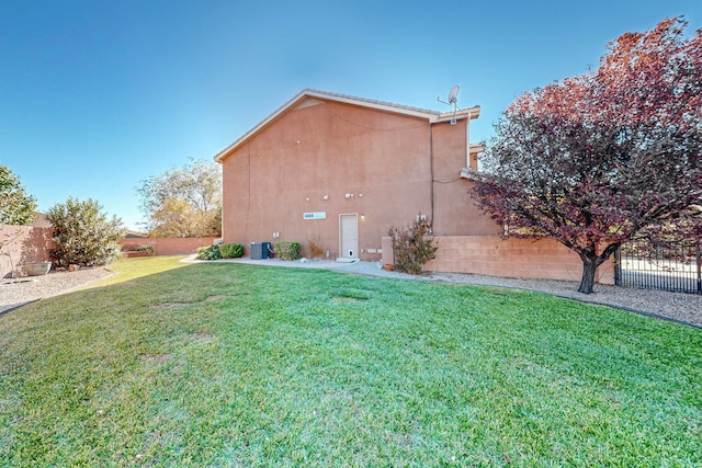 view of side of home featuring a yard