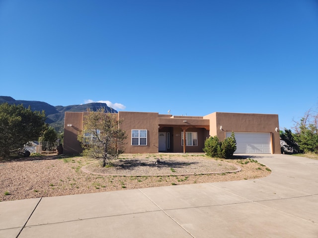 southwest-style home featuring a mountain view and a garage