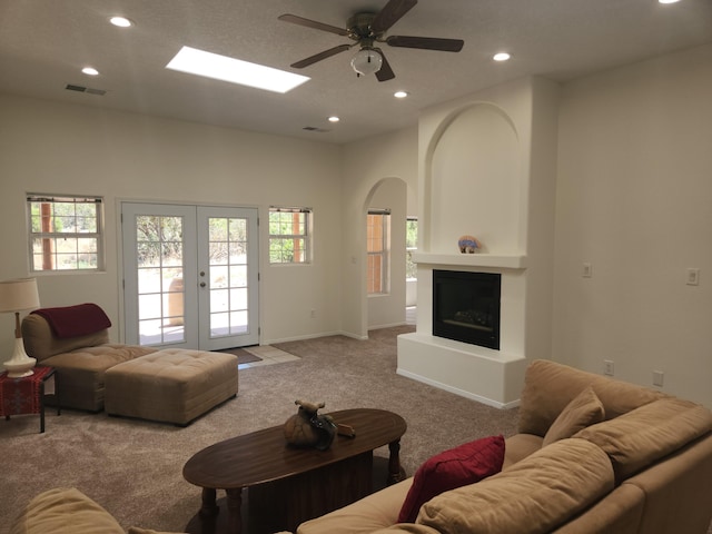 living room featuring light carpet, ceiling fan, and french doors