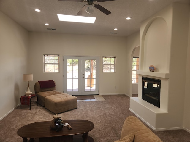 living room featuring carpet floors, french doors, and ceiling fan