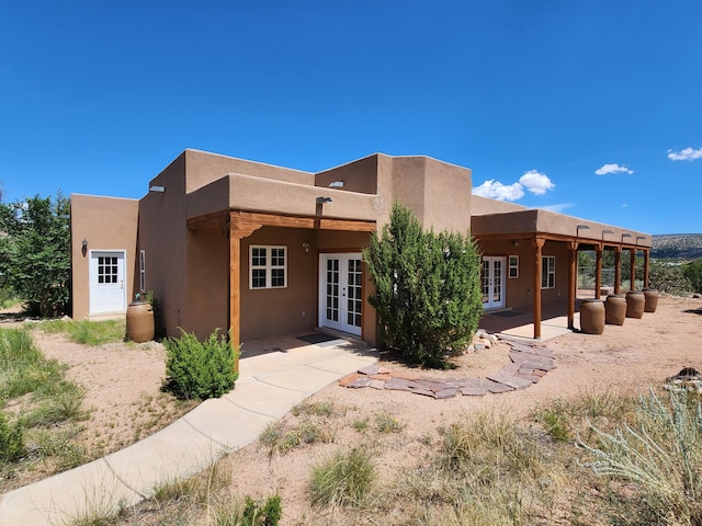 rear view of property featuring a patio area and french doors