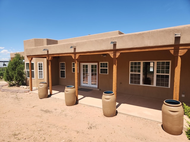 rear view of property featuring a patio and french doors