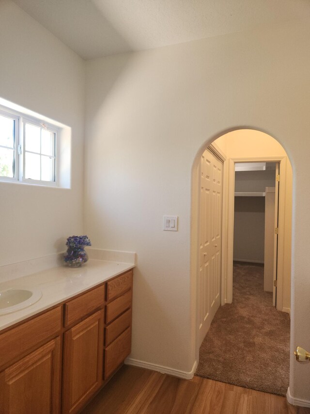 unfurnished bedroom featuring ceiling fan, a textured ceiling, and dark colored carpet