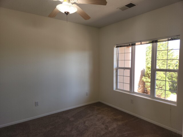 interior space featuring ceiling fan and dark colored carpet