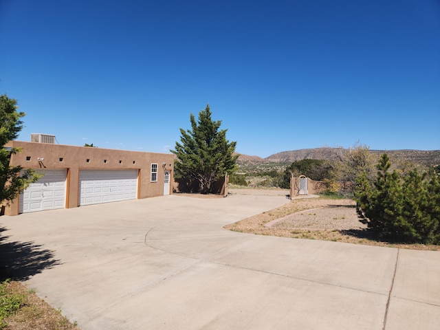 adobe home with a mountain view and a garage