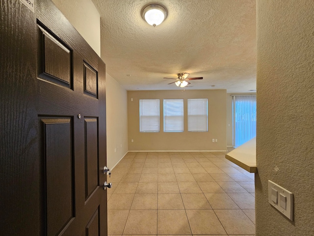 entryway with a textured ceiling, a healthy amount of sunlight, and ceiling fan