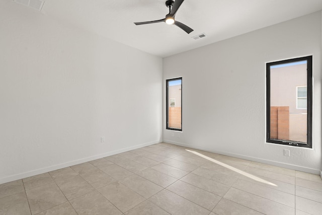 unfurnished room with ceiling fan and light tile patterned flooring