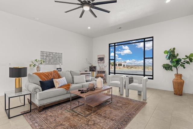 living room featuring light tile patterned floors and ceiling fan